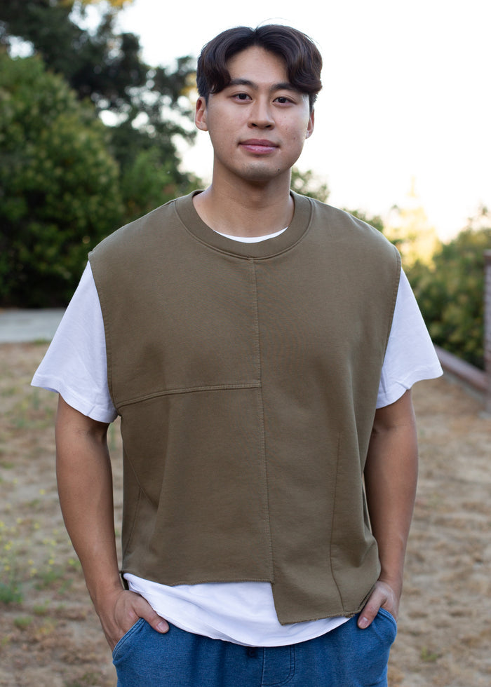 man wearing olive colored vest