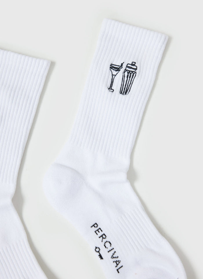Close-up of the Percival Mixologist Embroidered Socks in white, showing the cocktail glass and shaker embroidery detail.