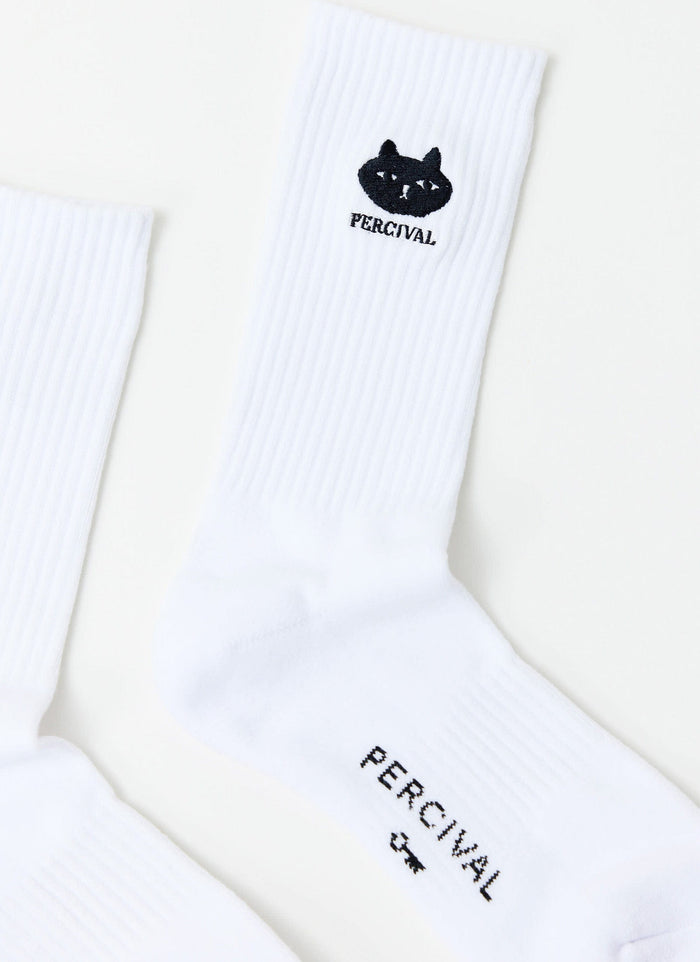 Close-up of the Percival Perci Loaf socks in white, showing the embroidered black cat detail on the ribbed ankle.