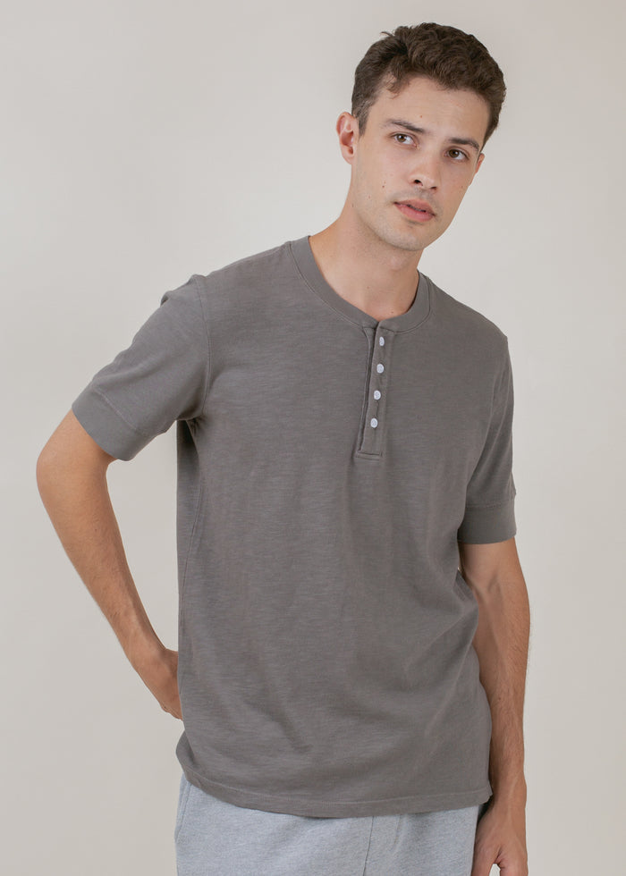 man wearing henley tee in cement grey