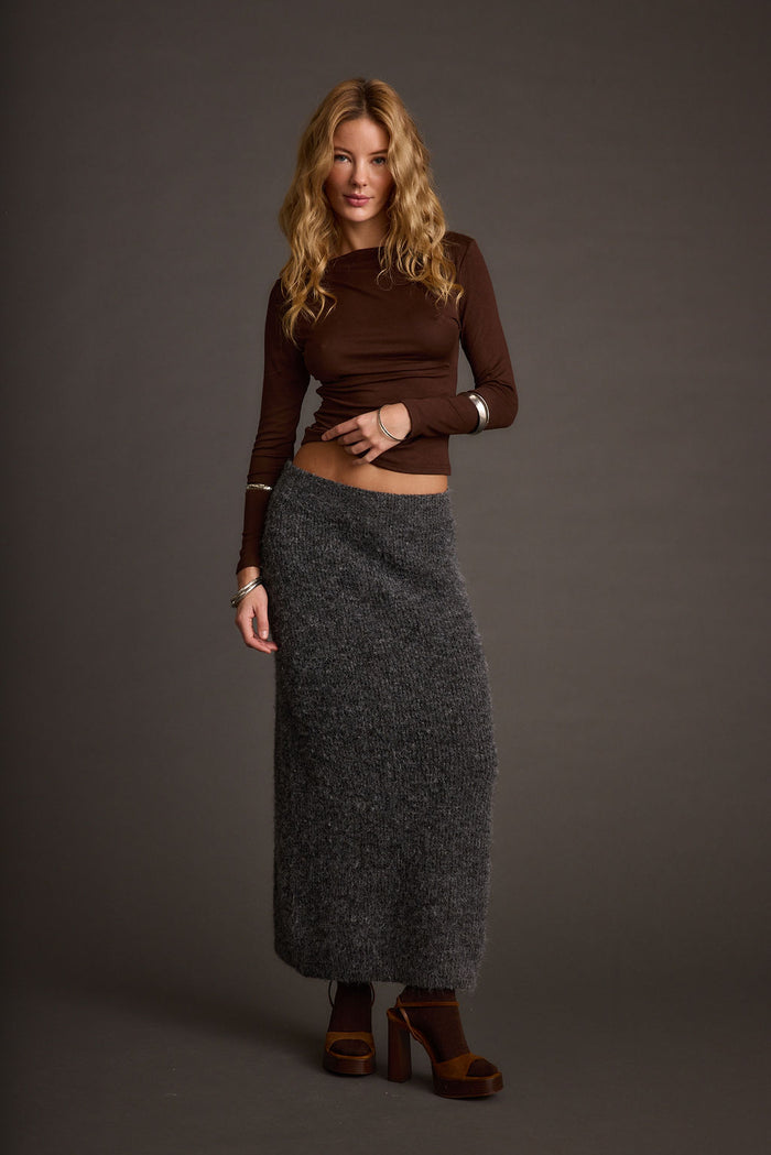 Sweater with elegant accents, a lace maxi skirt essential.