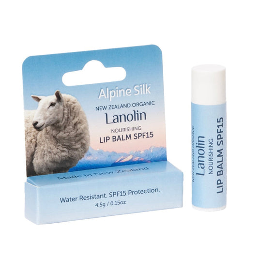 Pale blue lip balm next to packaging with image of sheep.