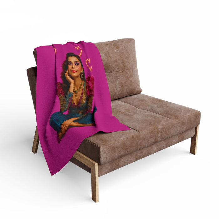 Arctic fleece blanket with colorful heart pattern wrapped around a woman for a cozy bedroom or living room lifestyle display.