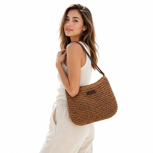 Khaki straw beach tote bag with zipper styled beside neutral summer accessories.