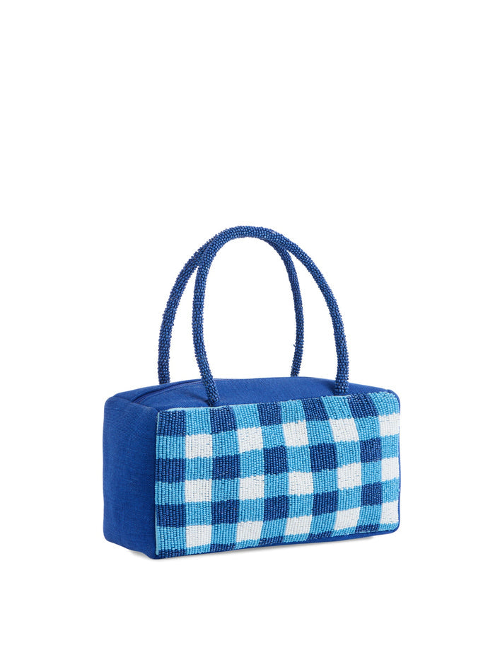 Backside of blue and white checkered handbag on a white background