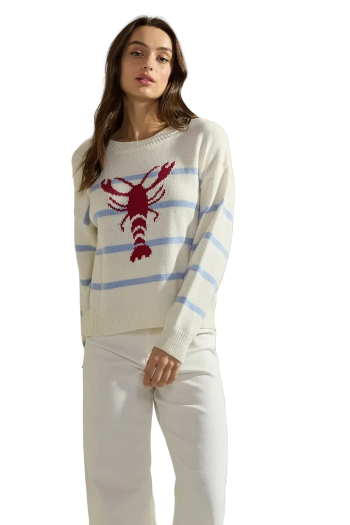 Woman wearing a sweater with a red lobster design on a beige background