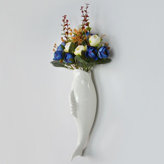 White hanging wall vase with sculpted goldfish relief presented as a ceramic decorative accent for coordinated interiors too.