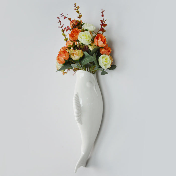 Goldfish ceramic wall vase shown as modern indoor decor for bedrooms, living rooms, entrances and restaurant interior spaces.