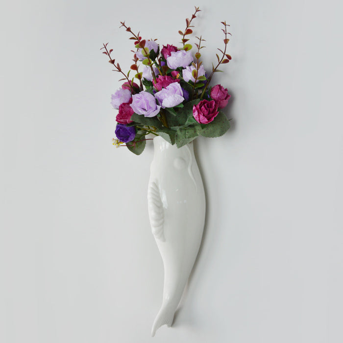 Decorative white ceramic wall vase with raised fish design adding sculptural interest to interior walls and room styling art.