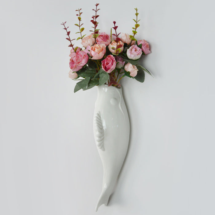 Modern wall mounted ceramic vase with 3D goldfish motif shown as a white decorative accent for home and restaurant interiors.