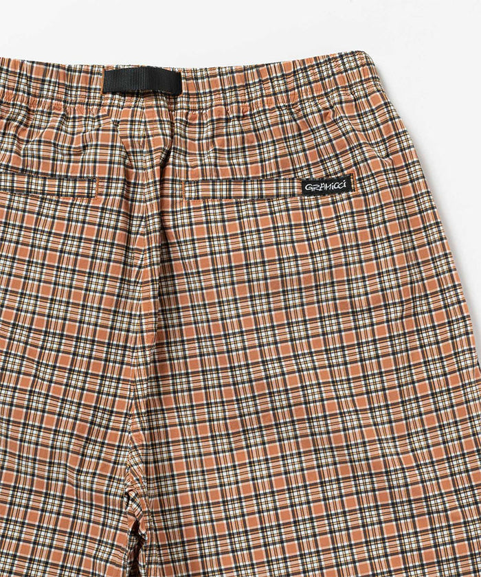 Back view close-up of brick check colored Gramicci Checkered Shell Shorts on a light-tone background.