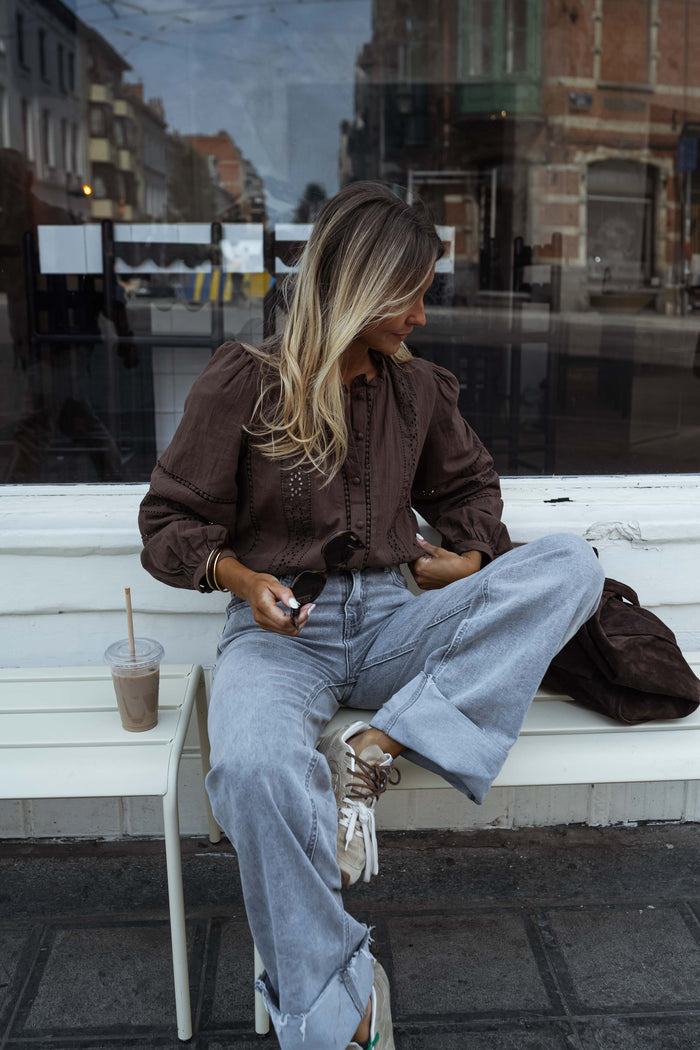 Chocolate brown openwork blouse styled with grey jeans
