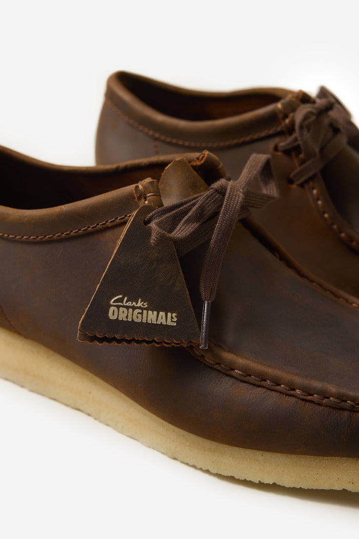 A close-up of the Clarks Originals Wallabee shoe in beeswax leather, showing the iconic branded tag, available at Percival.