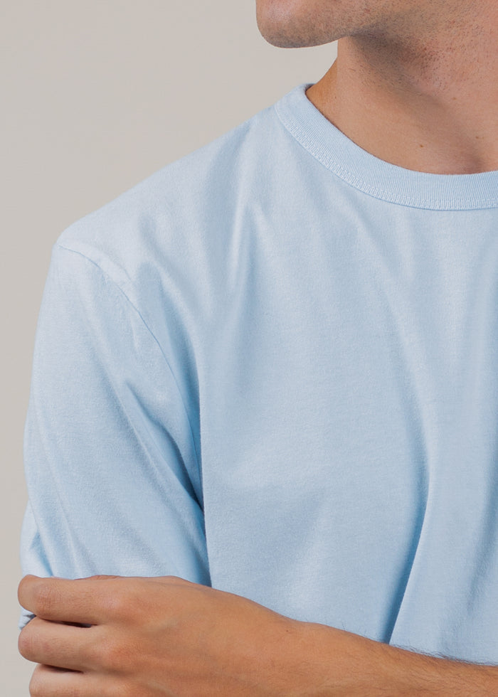 detail shot of man wearing t-shirt in sky blue