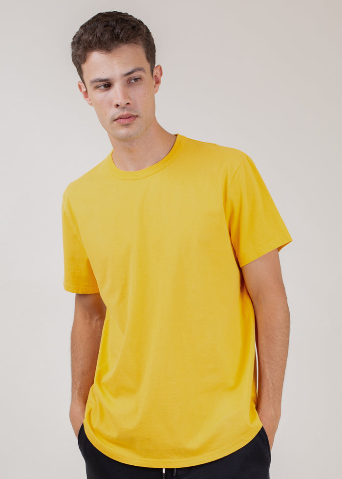 man wearing t-shirt in gold