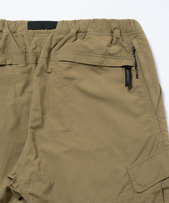 Back view close-up of khaki Gramicci Convertible Cargo Pants on a light-tone background.