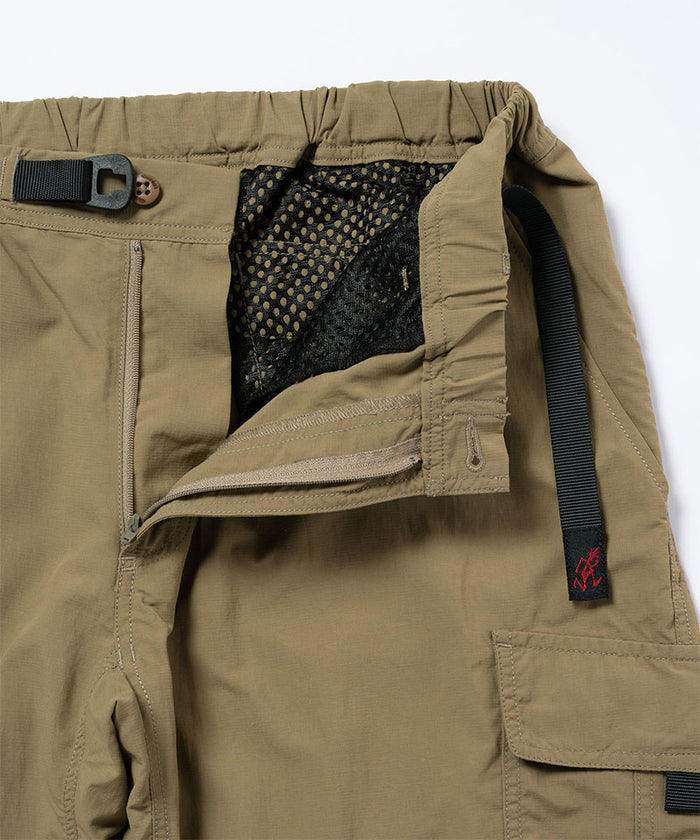 Close-up view of khaki Gramicci Convertible Cargo Pants on a light-tone background.
