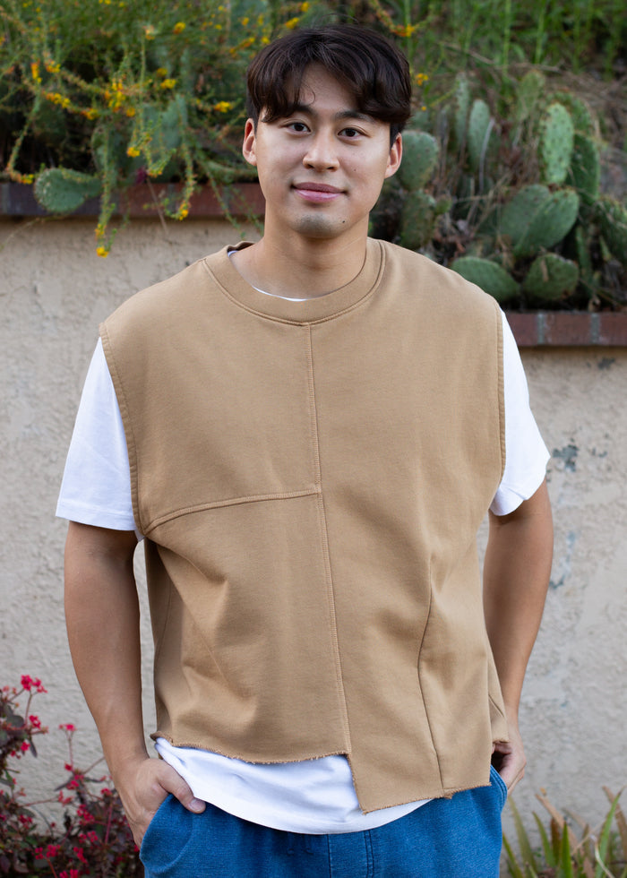 man wearing camel colored vest