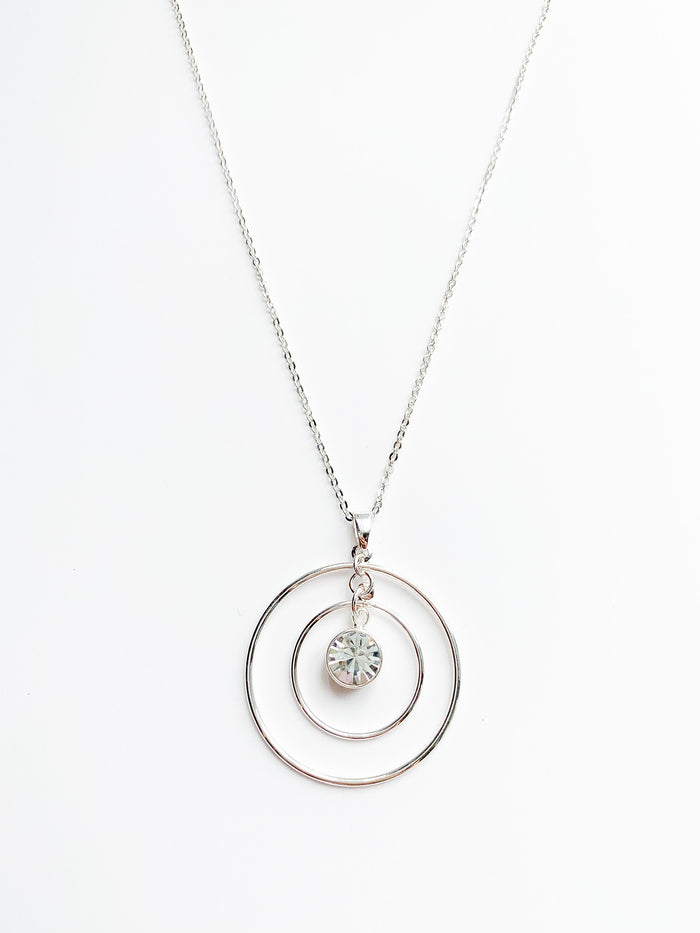 danielle long silver necklace. 2 halos around a crystal pendent.