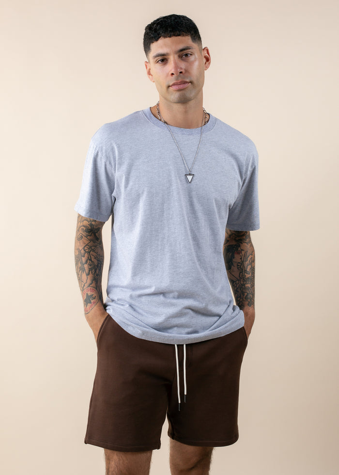 man wearing oversized deadstock tee in heather grey