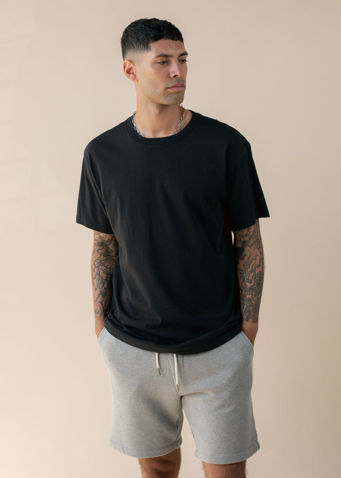 man wearing oversized deadstock tee in black