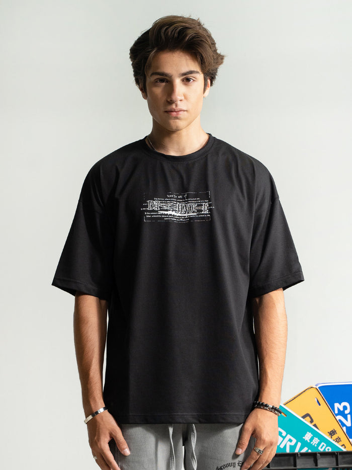 Death Note tee male model side angle black oversized anime streetwear Pakistan – GROOVY