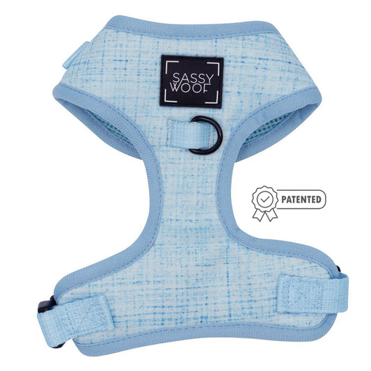 The Dog Adjustable Harness - Blumond by Sassy Woof features a light blue textured design, adjustable straps, a black D-ring for leashes, and a black “Sassy Woof” label. A “Patented” icon appears next to the harness.