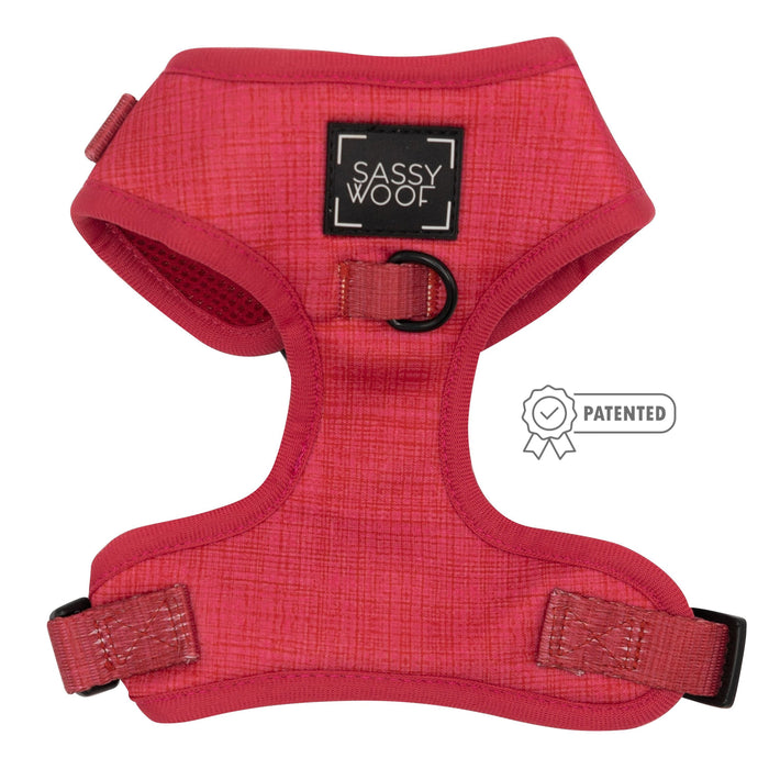 The Sassy Woof Dog Adjustable Harness - Merlot features sturdy straps and a black patch with the brand name. A patented emblem appears next to this no-pull dog harness.