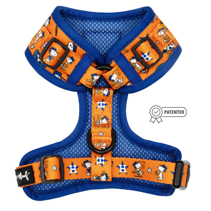 The Sassy Woof Dog Adjustable Harness - MLB™ x Peanuts™ Houston Astros™ features vibrant orange and blue colors, Snoopy graphics, adjustable straps, chest ring, breathable mesh, and a patented badge—part of the official collaboration.
