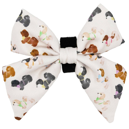The Sassy Woof Dog Sailor Bow - Spunky Shih Tzus features a white fabric with a black center and vibrant cartoon Shih Tzus—perfect to pair with our adjustable harness or as a stylish addition to your dog’s accessories.