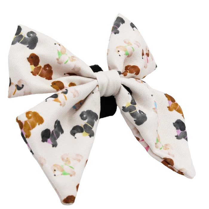 Add a playful touch to your collection with the Sassy Woof Dog Sailor Bow - Spunky Shih Tzus, featuring colorful dog patterns and a chic black center—perfect for pairing with your favorite accessories.