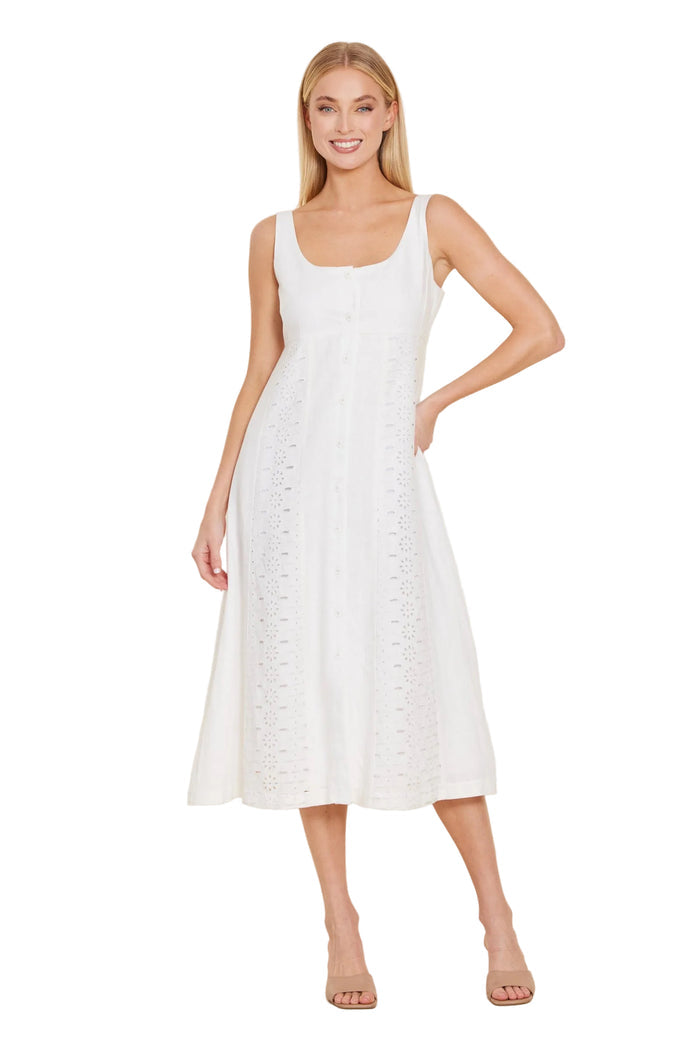 Woman wearing a white dress against a beige background