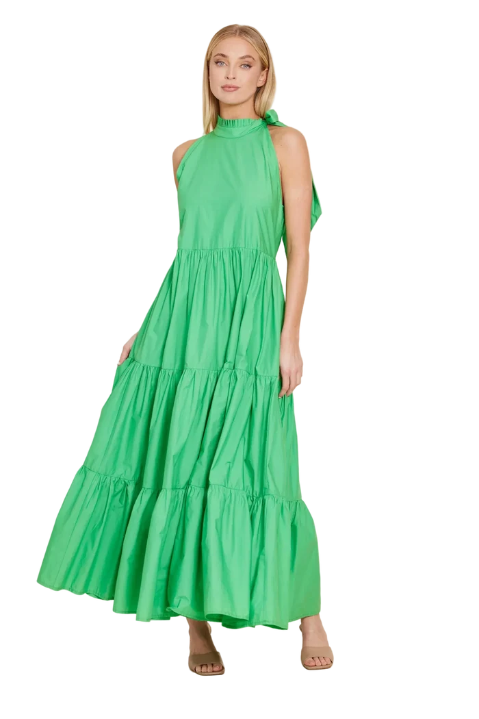 Woman wearing a green dress against a beige background