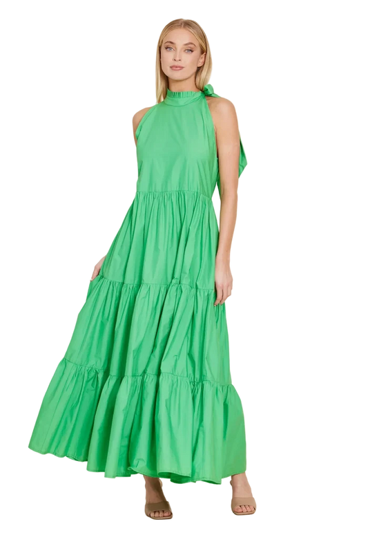 Woman wearing a green dress against a beige background