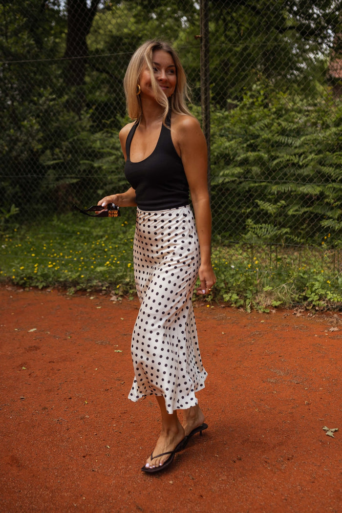 Black and ecru polka dot satin skirt styled with black tank