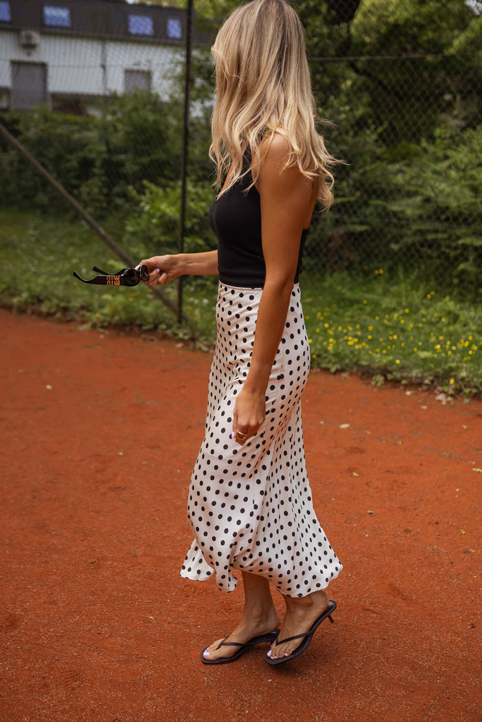 Black polka dot satin midi skirt, three quarter view