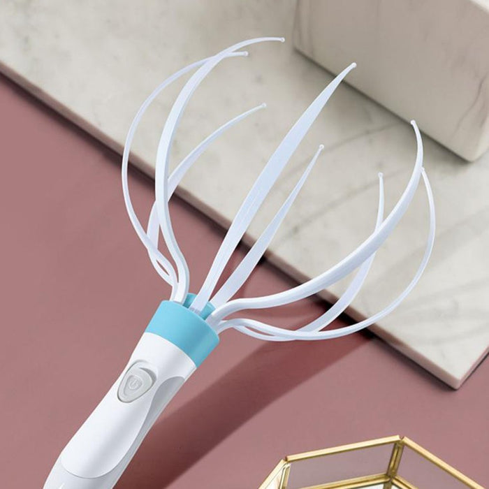 Handheld scalp massager shown during a personal care routine with eight flexible claws positioned across the top of the head.