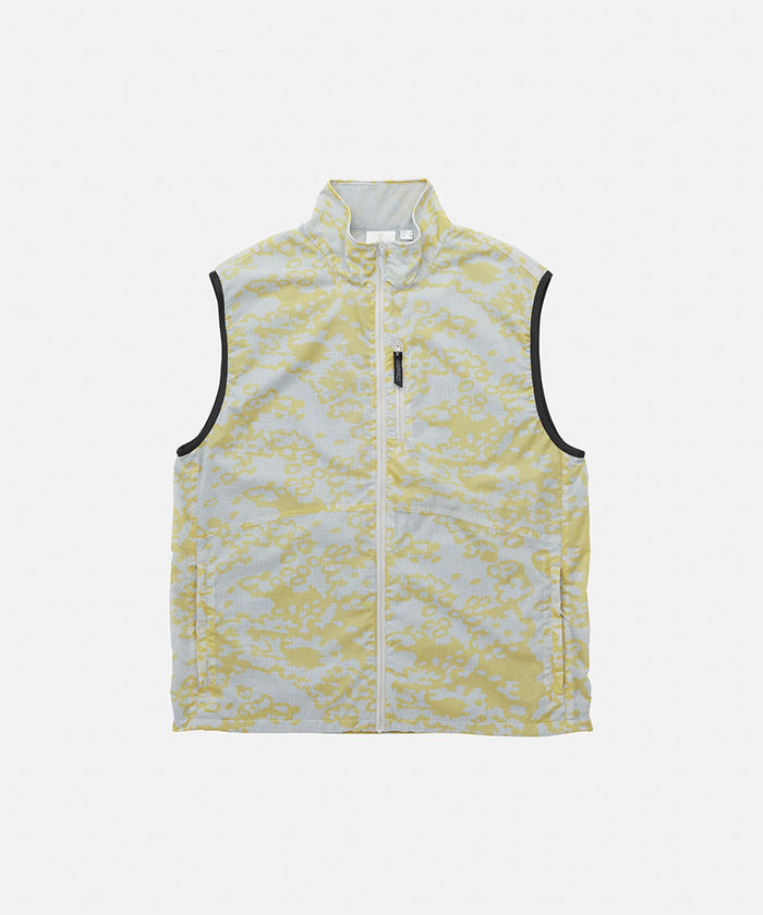 Gramicci yellow and grey grid camo Flyweight Vest against a light-tone background.