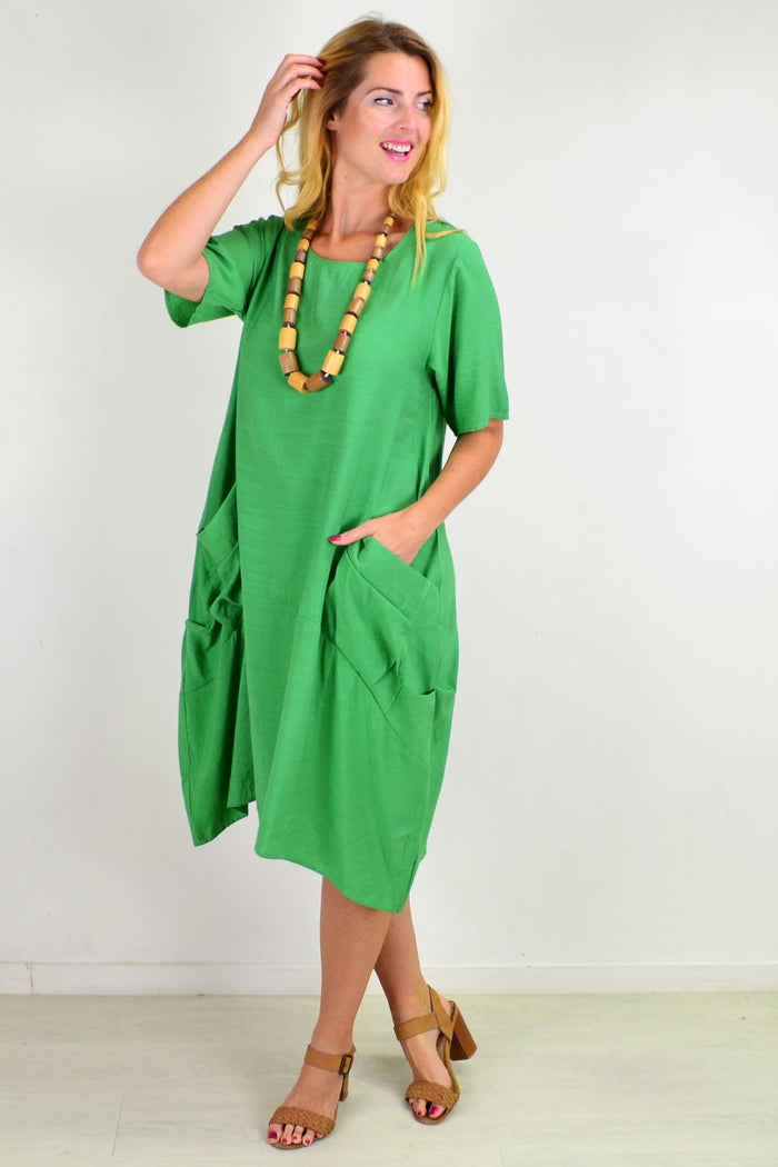 Green Grass Pocket Bubble Tunic Dress by La Mode, featuring a loose fit, green fabric, and pocket details, displayed on a mannequin.
