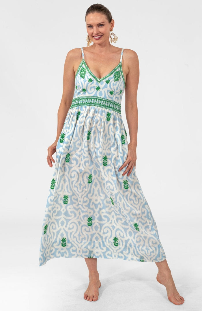 Woman wearing a patterned dress on a white background