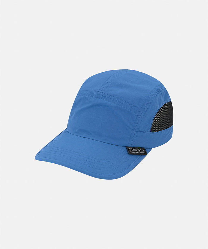 Blue Gramicci Guide Cap against a light-tone background.