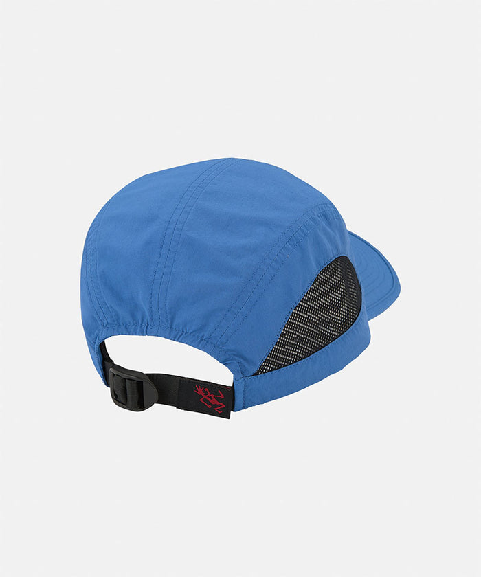 Back view of a blue Gramicci Guide Cap against a light-tone background.