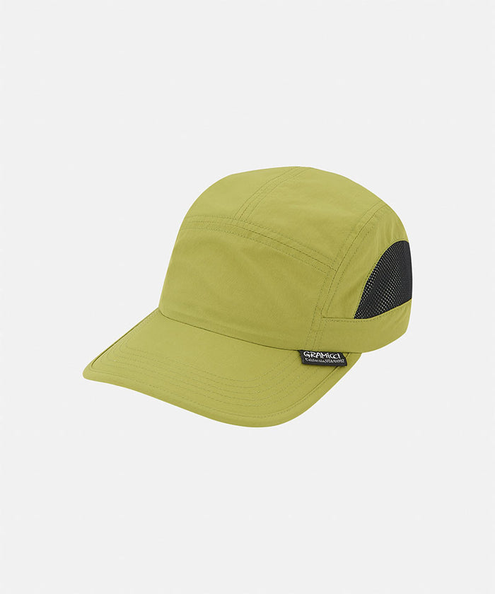 Field green Gramicci Guide Cap against a light-tone background.