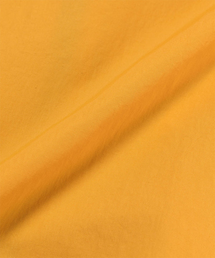Gramicci mango colored Guide Jacket fabric swatch.