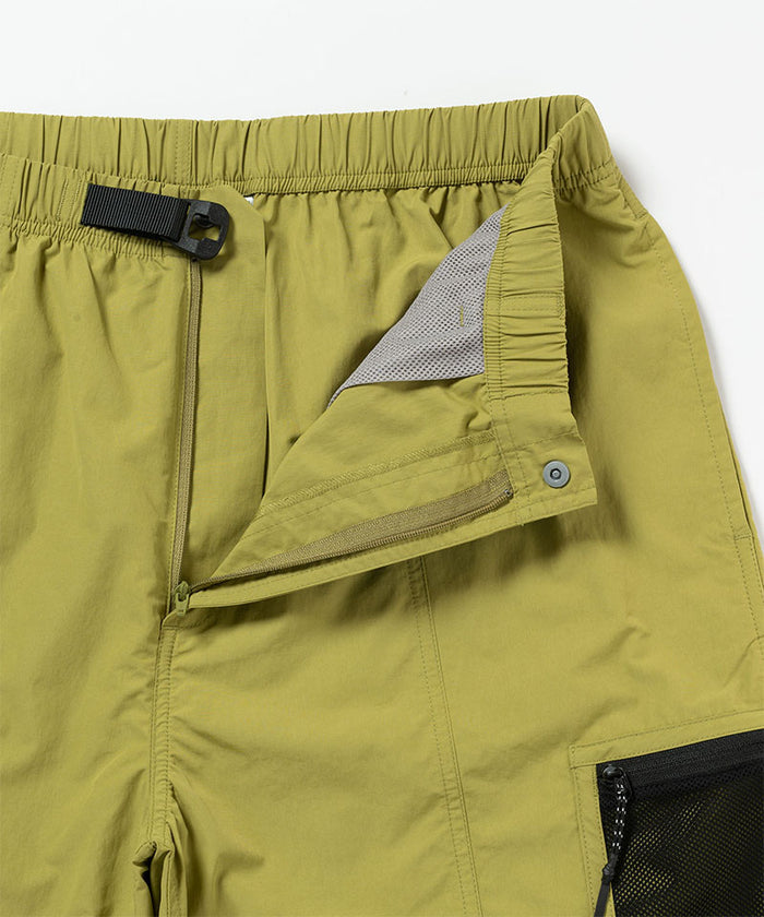 Close-up of Gramicci Guide Shorts in the color field green against a light-tone background.