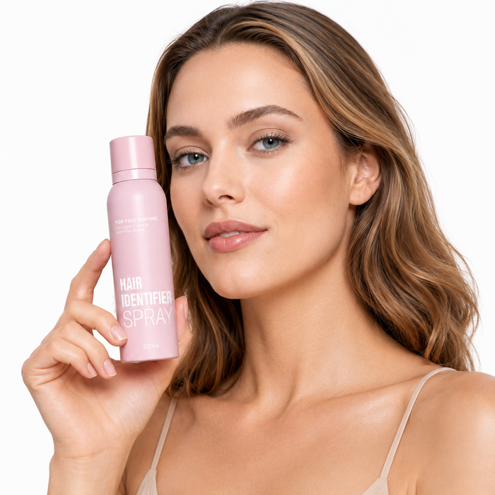 Hair Identifier Spray 100 ml bottle held beside a professional model's face on a clean white background for product viewing.
