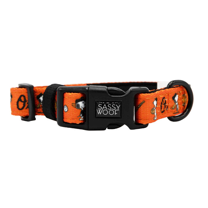 The Sassy Woof Dog Collar - MLB™ x Peanuts™ Baltimore Orioles™ features an orange design with a black plastic buckle and playful Peanuts characters—ideal for Orioles fans seeking a fun, sporty look for their pup.