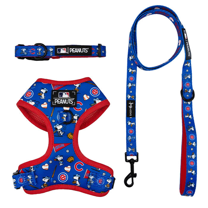 The Sassy Woof Harness Three Piece Bundle - MLB™ x Peanuts™ Chicago Cubs™ features blue and red Snoopy baseball designs, Cubs logos, baseballs, hearts, “MLB Peanuts” branding, and includes a matching leash.