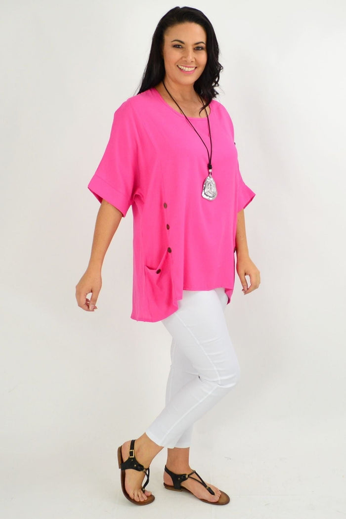 Hot pink Wishstone tunic top with coconut buttons and sloping sleeves, featuring a relaxed fit and stylish design.