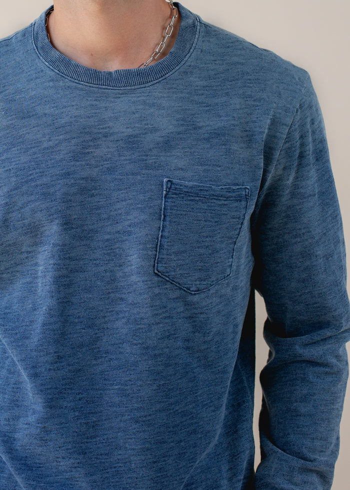 close up of man wearing indigo long sleeve in medium wash
